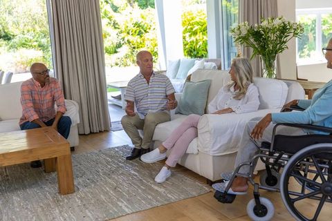 Senior Friends Engaging in Relaxing Conversation at Bright Living Room