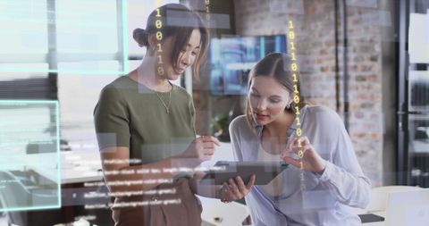 Diverse Professionals Collaborating on Digital Data in Modern Office