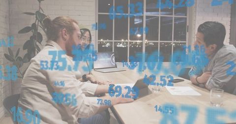 Team Collaborating on Financial Analytics Around Conference Table at Night with Blue Data Overlay