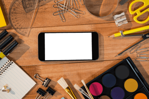 Transparent Mobile Phone Surrounded by Office Stationery