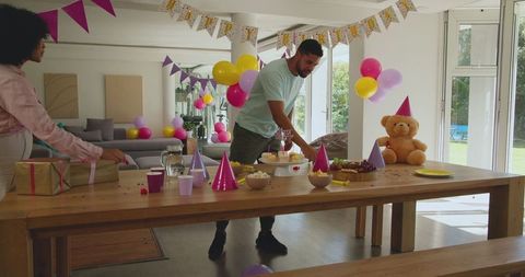 Family Setting Up a Joyful Birthday Party at Home