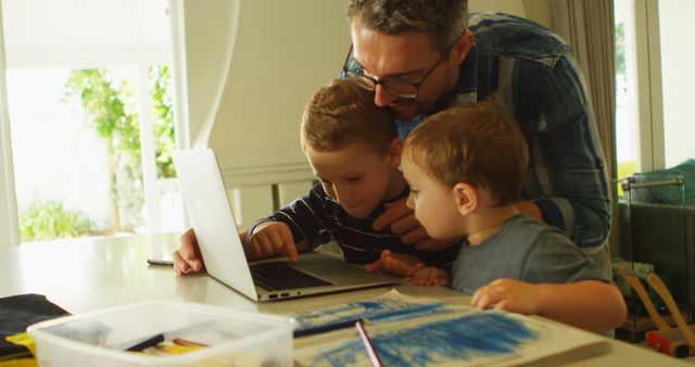 Father and Sons Learning Together Using Laptop at Home - Download Free Stock Images Pikwizard.com