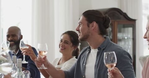 Friends Toasting Wine at Elegant Celebration Gathering