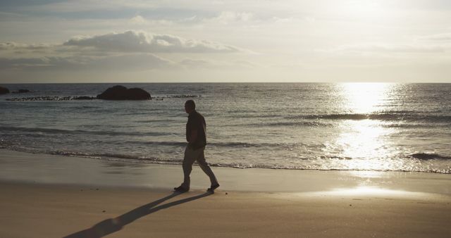 Man Walking on Beach During Sunset - Download Free Stock Images Pikwizard.com