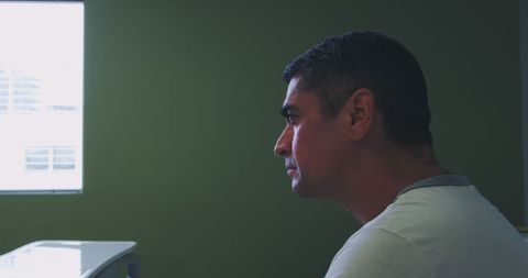 Thoughtful Patient in Hospital Room with Green Wall - Download Free Stock Images Pikwizard.com