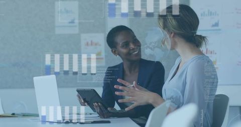 Professional Colleagues Analyzing Data with Digital Technology in Office