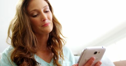 Woman Relaxing at Home Enjoying Smartphone Communication