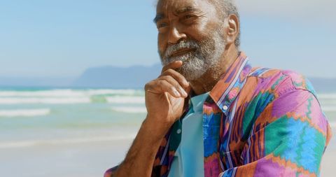 Thoughtful Senior Man Enjoying Relaxing Beach Day