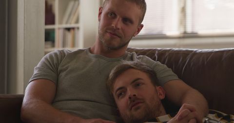 Happy Gay Couple Relaxing on Couch at Home