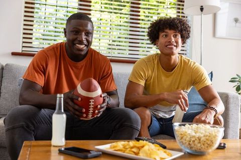 Friends Enjoying Sports with Snacks in Cozy Living Room