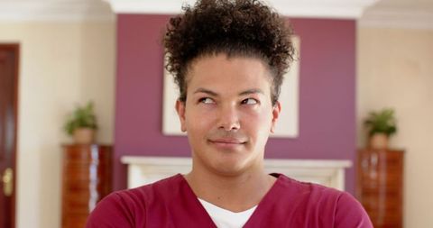 Confident man with crossed arms in cozy home interior