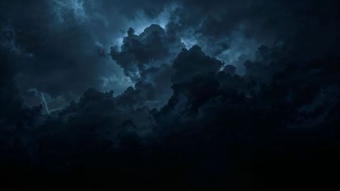 Dramatic storm clouds with negative energy lightning in night sky