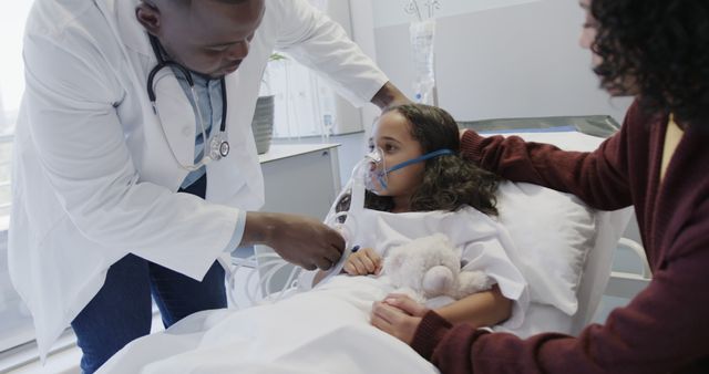 Doctor Examining Child Patient with Oxygen Mask in Hospital Bed - Download Free Stock Images Pikwizard.com