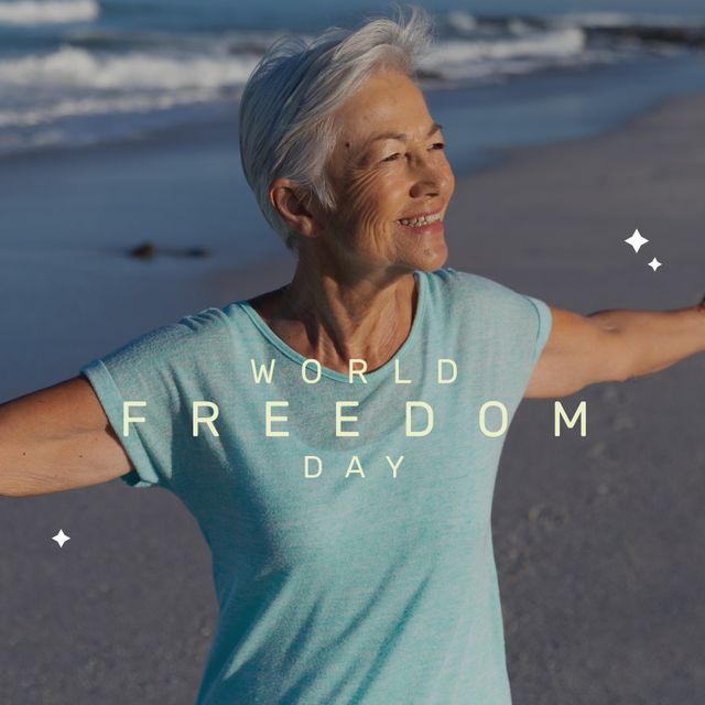 Image of world freedom day over happy senior biracial woman on beach. Freedom, holidays and vacations concept.