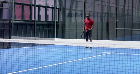 Athlete Holding Padel Racket on Urban Blue Court