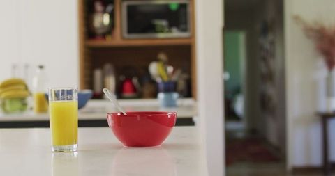 Morning Delight: Red Bowl and Juice on Modern Kitchen Counter - Download Free Stock Images Pikwizard.com