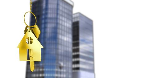 House Shaped Key Hanging Over Skyscrapers