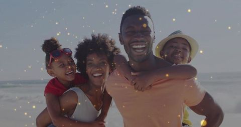 Happy Family Enjoying Beach Vacation with Piggyback Rides