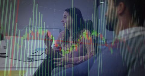 Business Team Analyzing Stock Market Data with Candlestick Charts Overlay