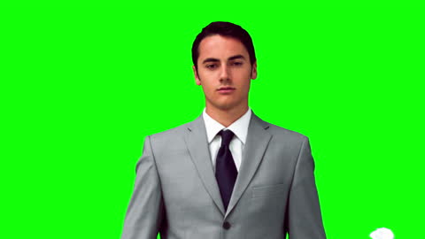 Confident Businessman Against Green Background with Floating Papers
