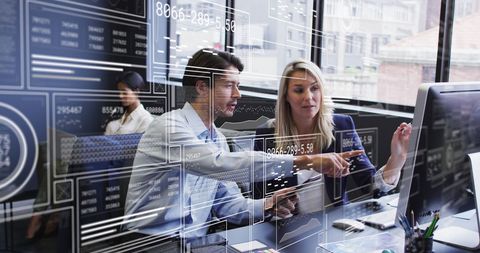 Coworkers discussing business reports with virtual interface overlays