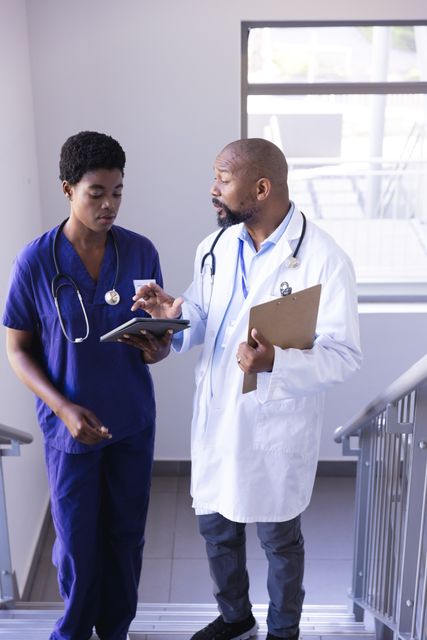 Doctors Discussing Patient Information on Staircase - Download Free Stock Images Pikwizard.com