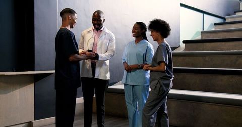 Healthcare team celebrating achievement in hospital