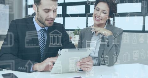 Business Colleagues Analyzing Data on Digital Tablet in Modern Office