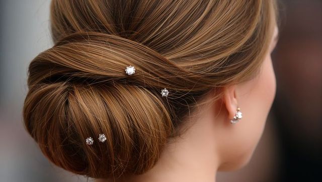 Showcasing Elegant Low Chignon with Crystal Hairpins and Sparkling Cluster Earrings