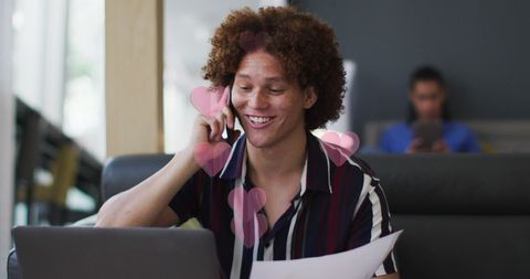 businessman enjoying a conversation over the smartphone while smiles highlight positive engagement. used for content focusing on remote work, communication technology, digital romance, or inclusive workplace. the heart graphics symbolize warmth and human connection in digital communications, suitable for social media tips, online teamwork articles, or business service advertisements.