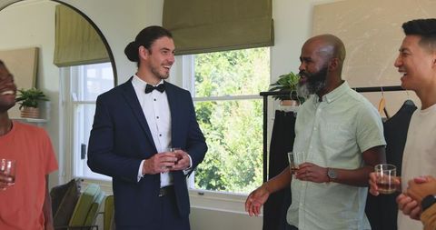 Groom and Friends Celebrating Wedding Day Indoors