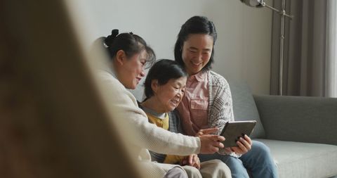 Multigenerational family using tablet for digital connectivity
