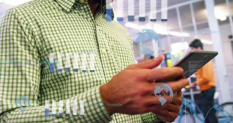 Business professional using tablet with augmented data visualizations in modern office