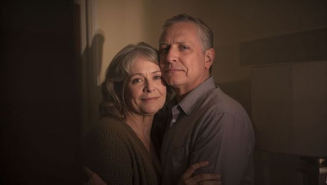 Mature couple embracing in warm home, sharing tenderness, companionship and quiet confidence