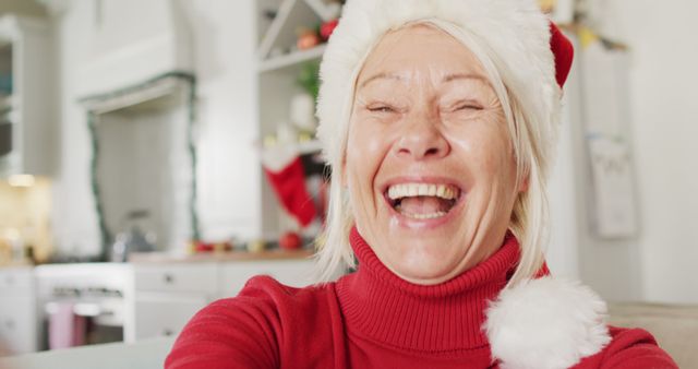 Happy senior caucasian woman wearing santa claus hat, having image call - Download Free Stock Photos Pikwizard.com