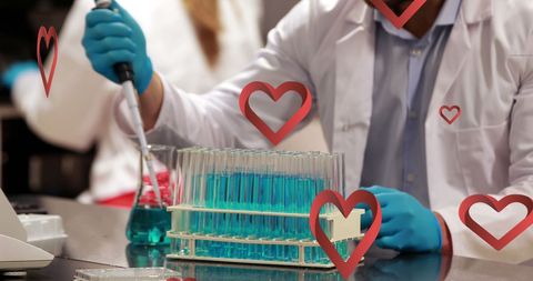 Scientist mixing chemical solutions with love icon overlays