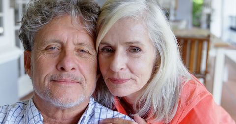 Smiling Senior Couple Embracing in Cozy Home Environment