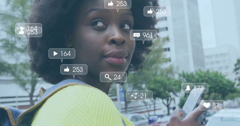 African American Woman Using Smartphone with Social Media Icons Overlay
