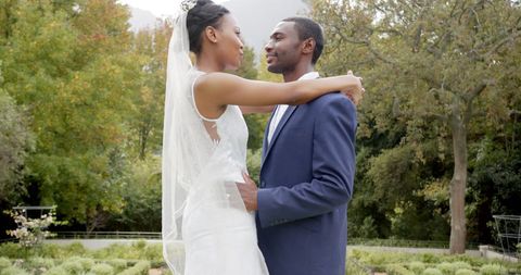 Romantic Newlyweds Embracing in Lush Garden Setting