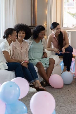 Diverse female friends relaxing at carefree celebration