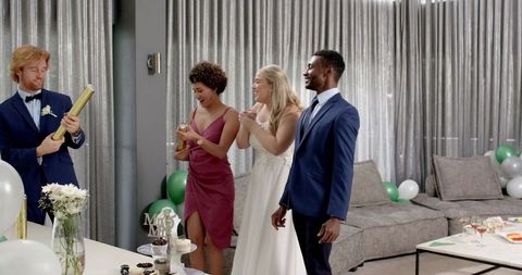 Diverse friends celebrating at modern wedding reception
