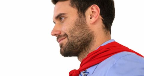 Confident Man with Red Superhero Cape on White Background