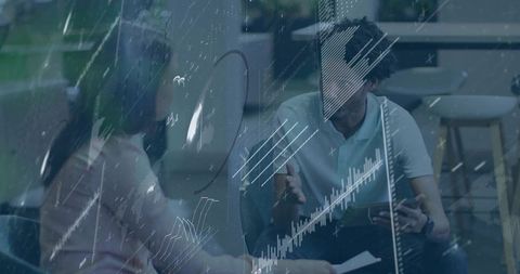 Business professionals reviewing tablet and documents collaborating with glass data overlay