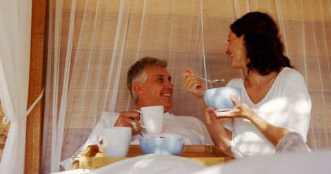 Happy Couple Enjoying Breakfast in Bed With Relaxed Atmosphere - Download Free Stock Images Pikwizard.com