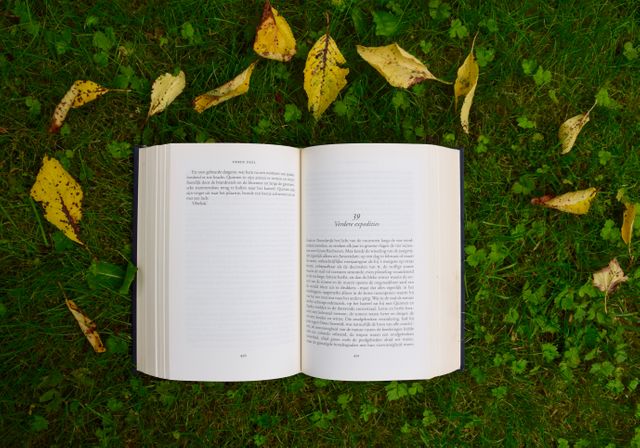 Open Book on Grass With Autumn Leaves - Download Free Stock Photos Pikwizard.com