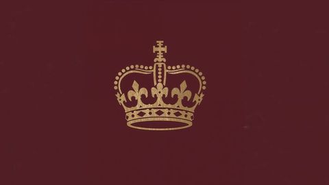 Golden british empire heraldic crown on maroon heraldry background