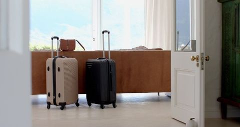 Modern Interior with Luggage and Travel Bag Near Sunny Window