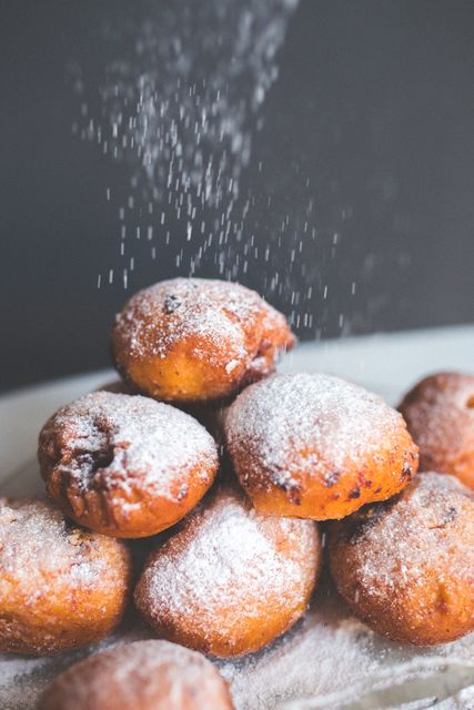 Freshly baked donuts dusted with powdered sugar - Download Free Stock Photos Pikwizard.com