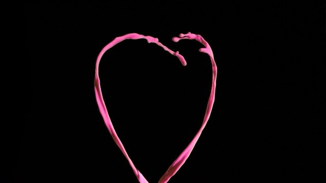 Elegant minimalistic heart shape created by pink lines rising against a black background. Perfect for romantic, Valentine’s Day, love-themed, and modern art designs. Suitable for greeting cards, posters, social media, and advertisements about relationships and affection.