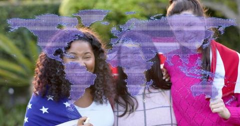 Smiling friends wrapped in flags celebrating global unity with purple world map overlay